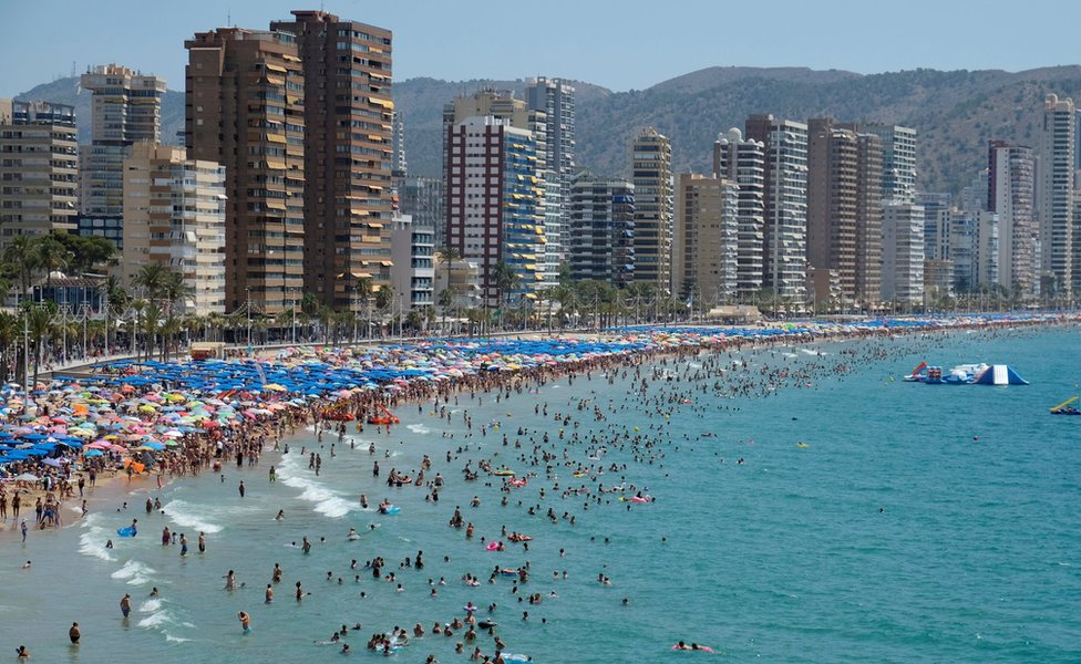 People cool off at the beach during the heatwave in the southeastern coastal town of Benidorm