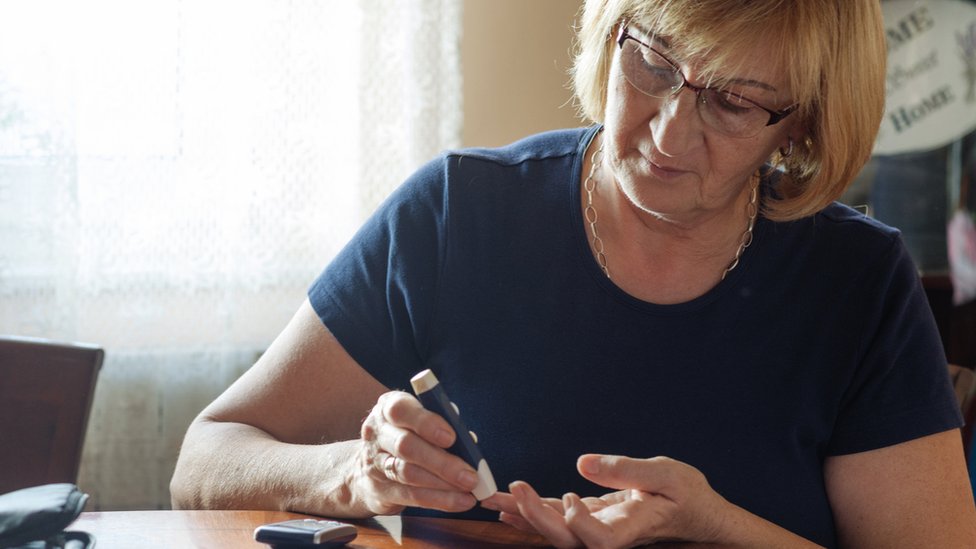 Woman testing blood sugars