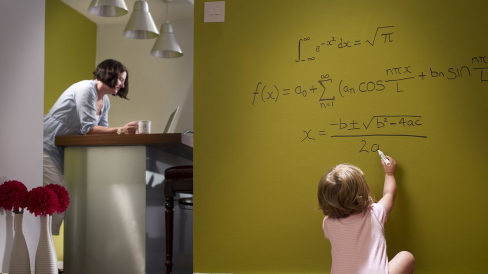 Child writing on blackboard