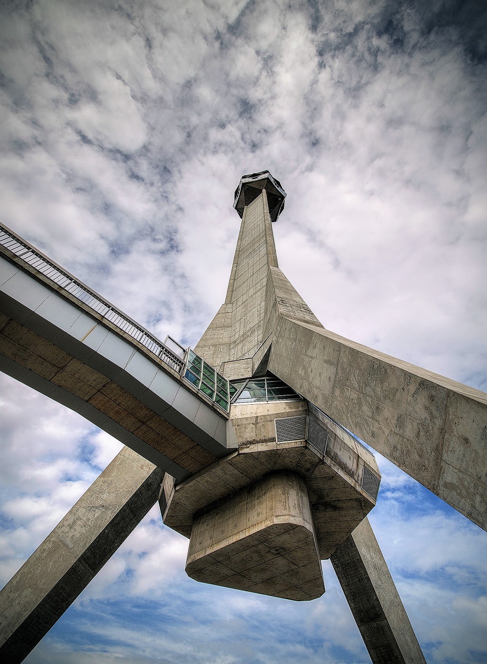 A concrete tower building in the shape of a tripod