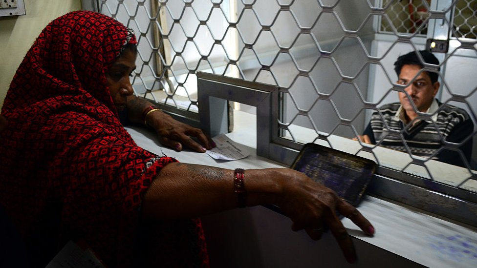 A woman withdraws money at her bank