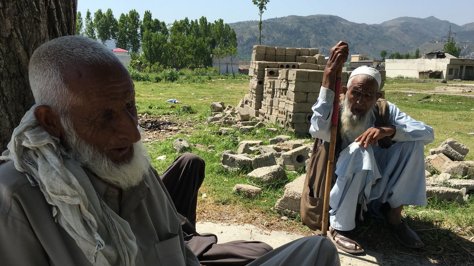 Zain Baba and a neighbour sat under the maple tree