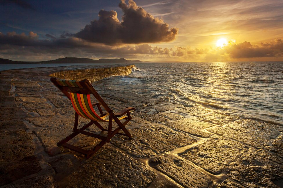 Deckchair on the beach at sunrise