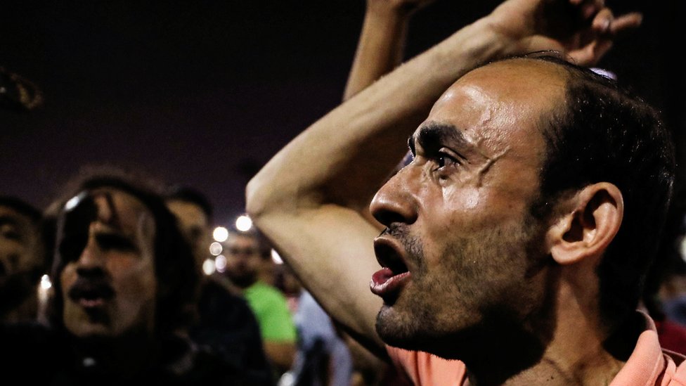 Small groups of protesters gather shouting anti-government slogans in central Cairo