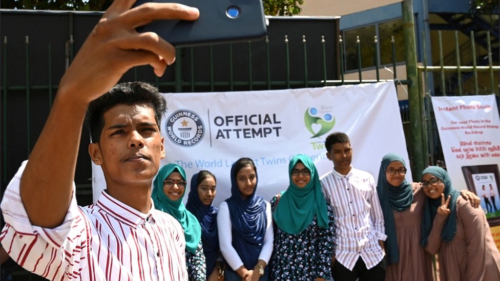 Sri Lankan twins pose for a group picture at the Sri Lanka twins event in Colombo on 20 January 2020