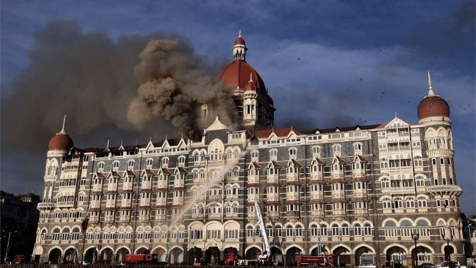 In this file photo taken on November 27, 2008 Indian fire-fighters attempt to put out a fire as smoke billows from the Taj Mahal Palace hotel in Mumbai.