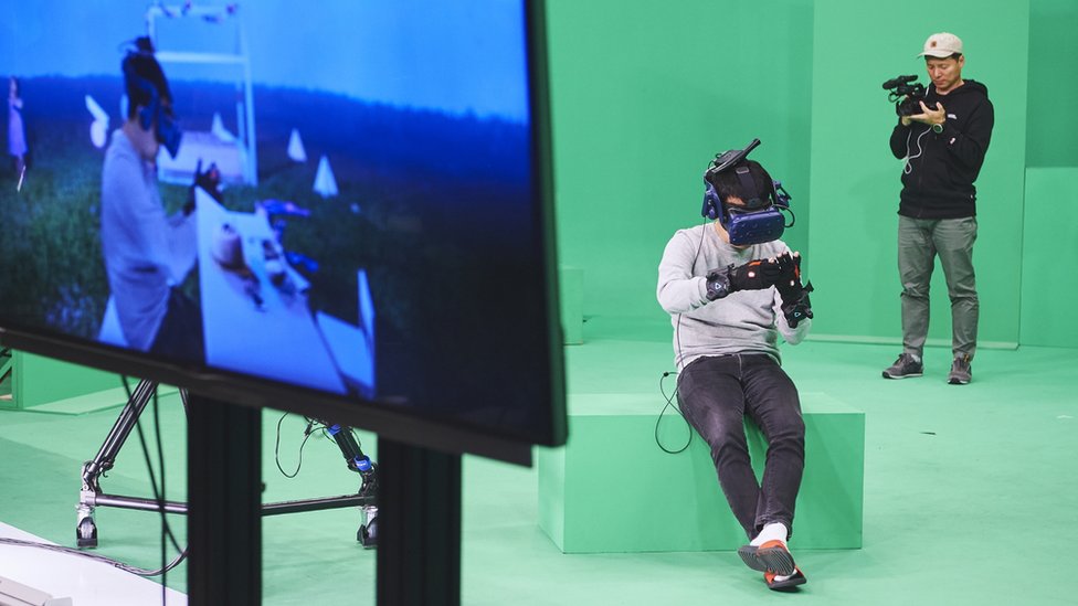 A press handout shows the crew testing the VR equipment ahead of filming