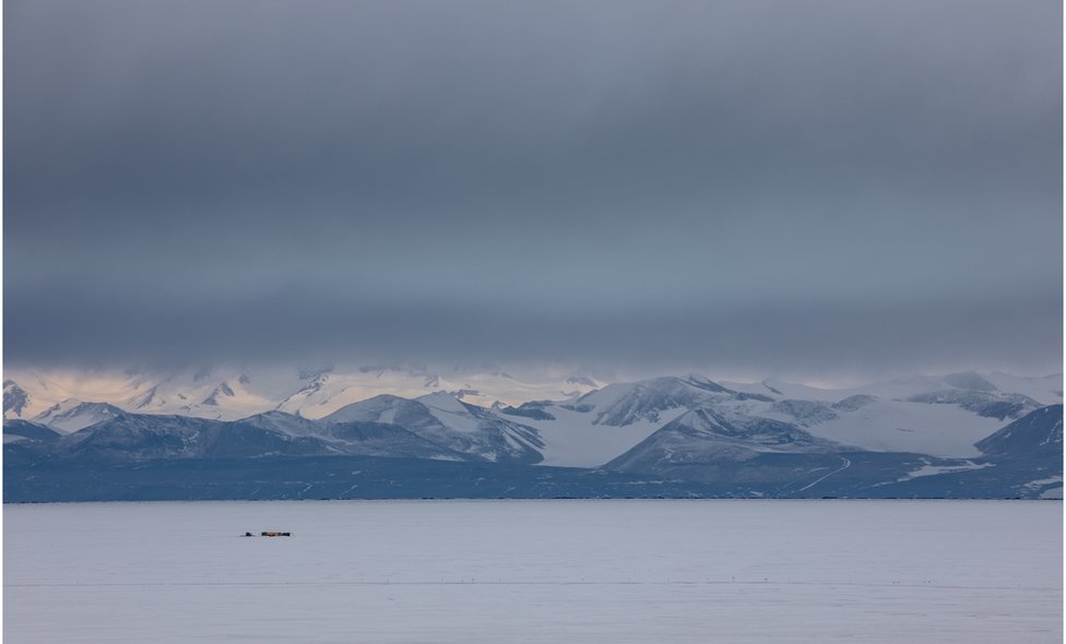 Antarctic landscape with mountains and tents