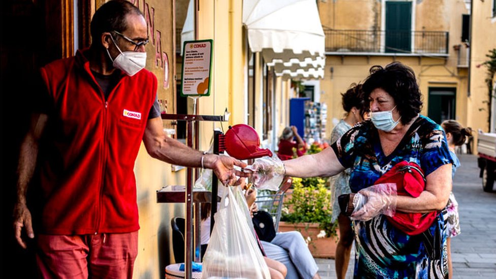 Tourists queue outside a supermarket in Ventotene, Italy.