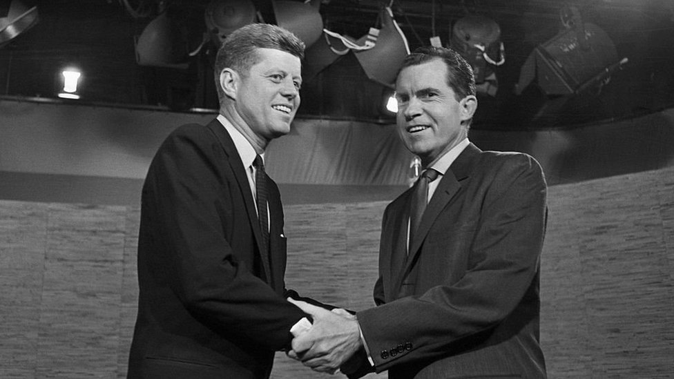 Presidential candidates John F. Kennedy and Richard Nixon shake hands after their televised debate of October 7, 1960.