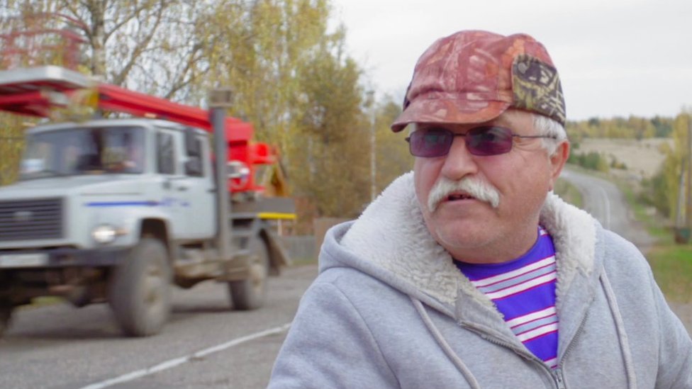 An Udgodskaya supporter stands by a roadside