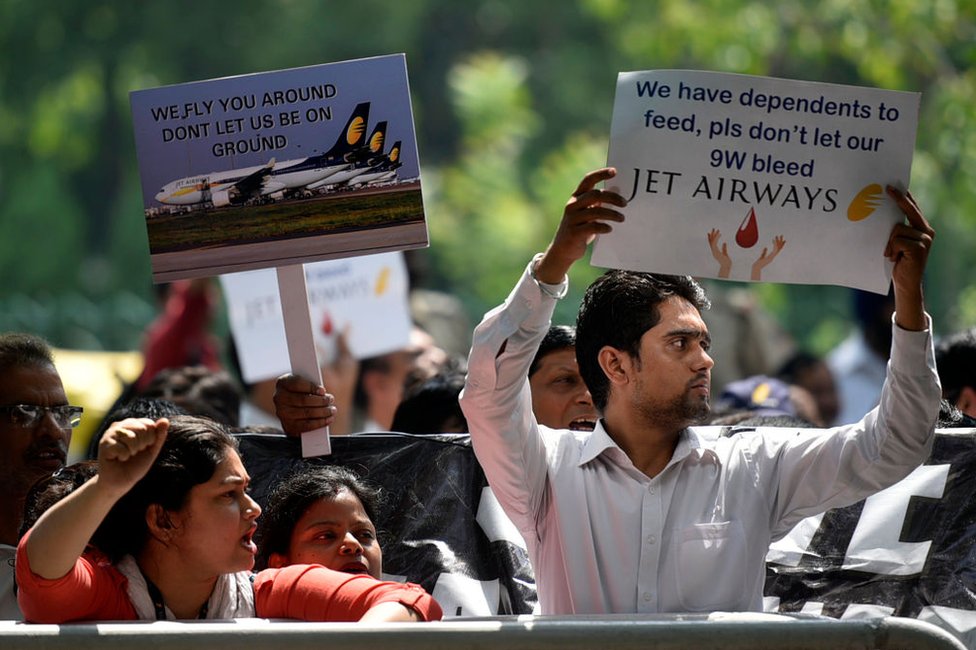 Jet Airways employees hold placards as they raise slogans during a protest against delayed salaries and the current shutdown crisis outside Rajiv Gandhi Bhawan at Jor Bagh on May 21, 2019 in New Delhi, India.