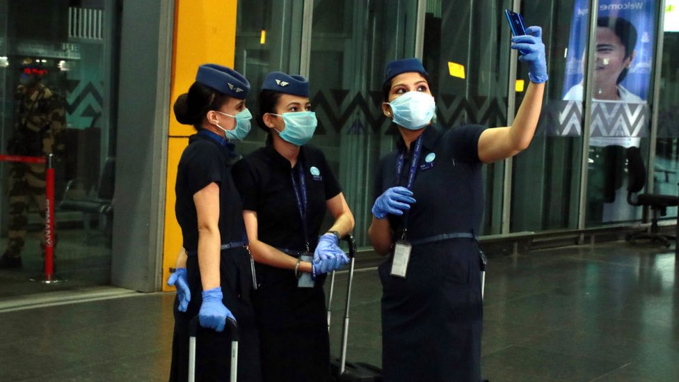 IndiGo Airlines Air hostess wearing protective mask posing for selfie on smartphone at the Netaji Subhas Chandra Bose International Airport on June 04, 2020 in Kolkata, India.