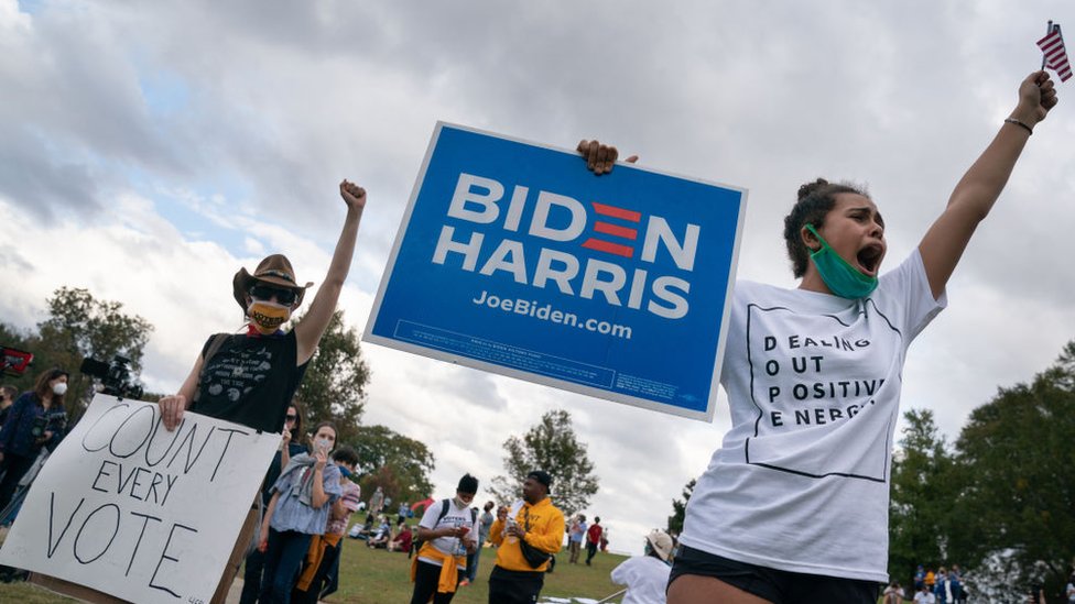 People celebrate Joe Biden's projected presidential win at Freedom Park on November 7, 2020 in Atlanta, Georgia