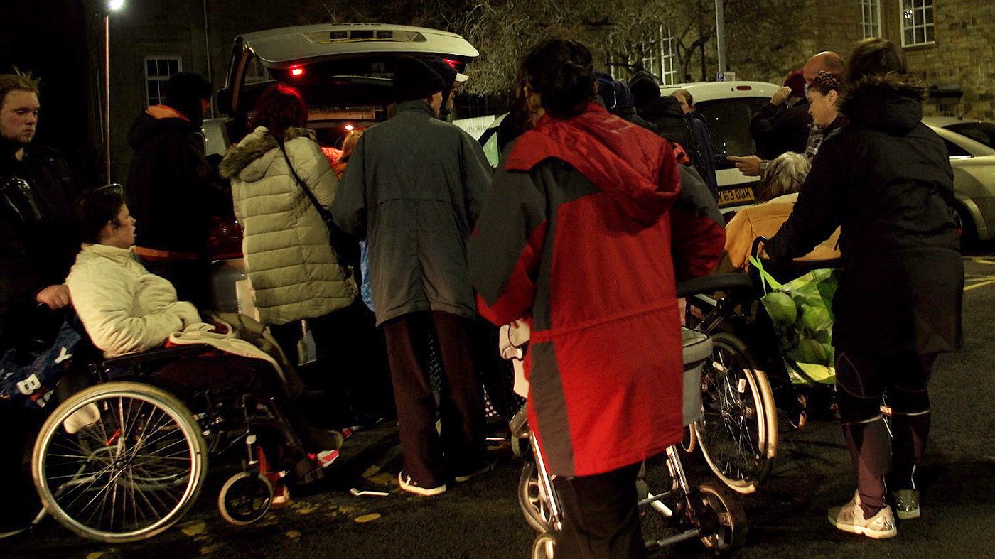 People crowd to receive hot food