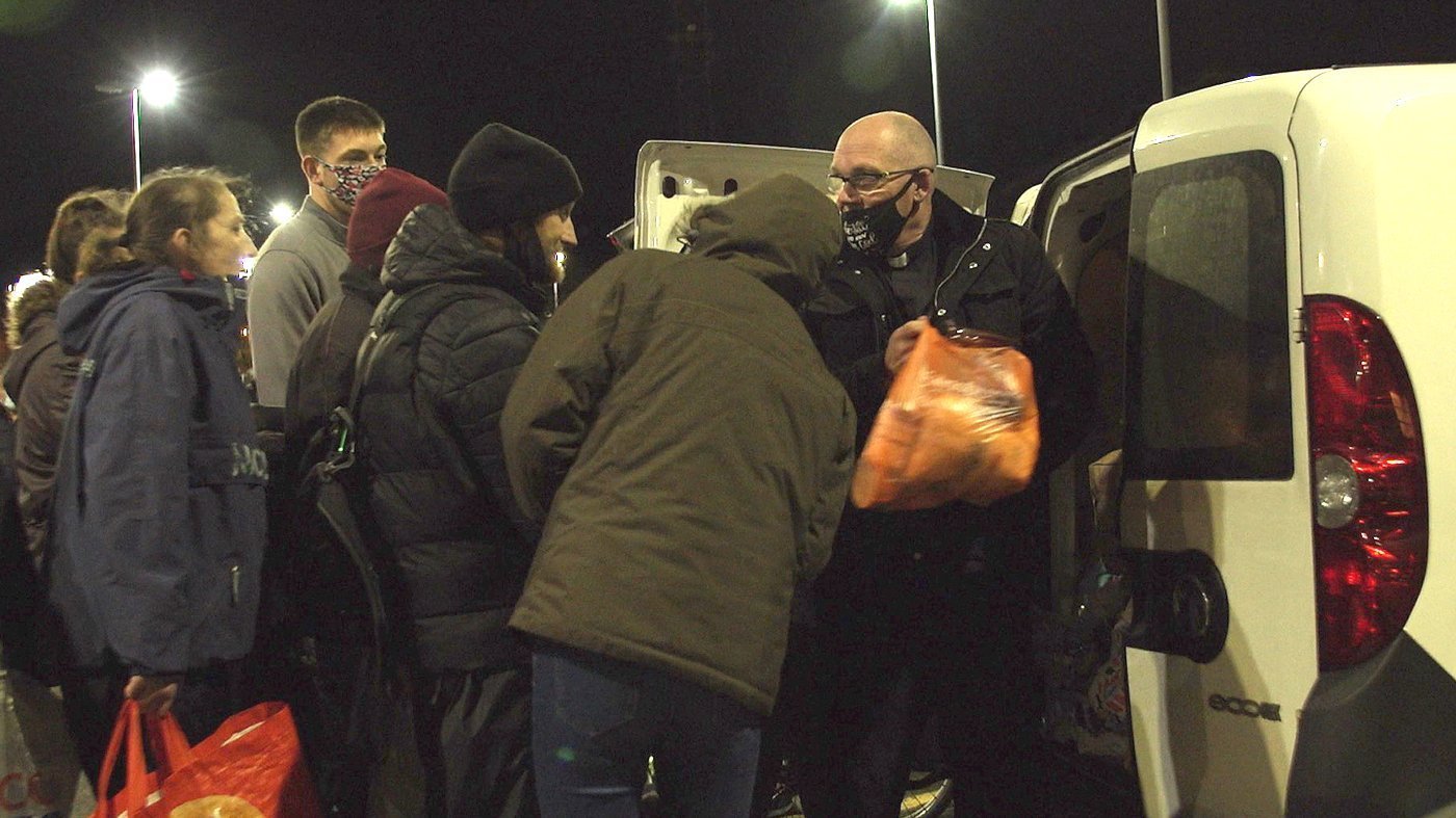 Pastor Mick Fleming hands out food