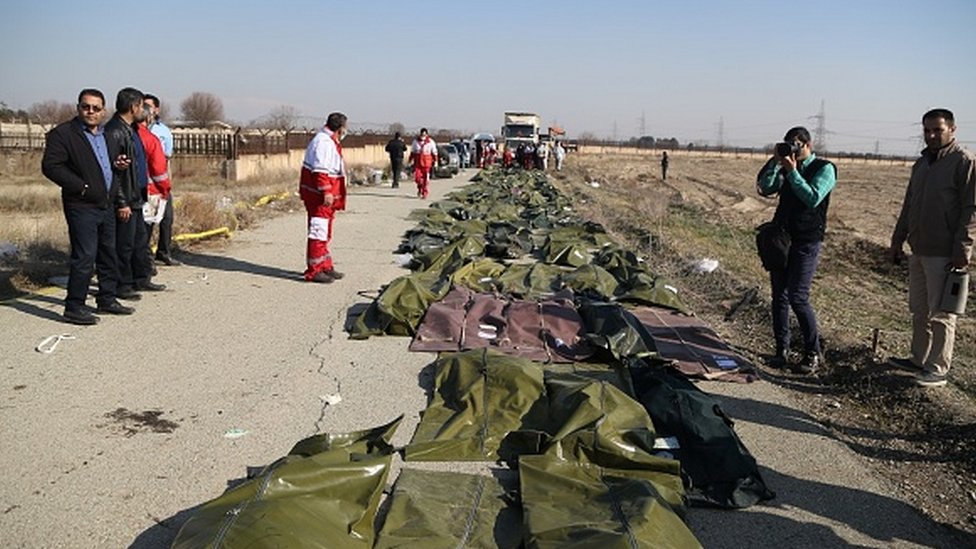 The bodies of those killed at the crash site