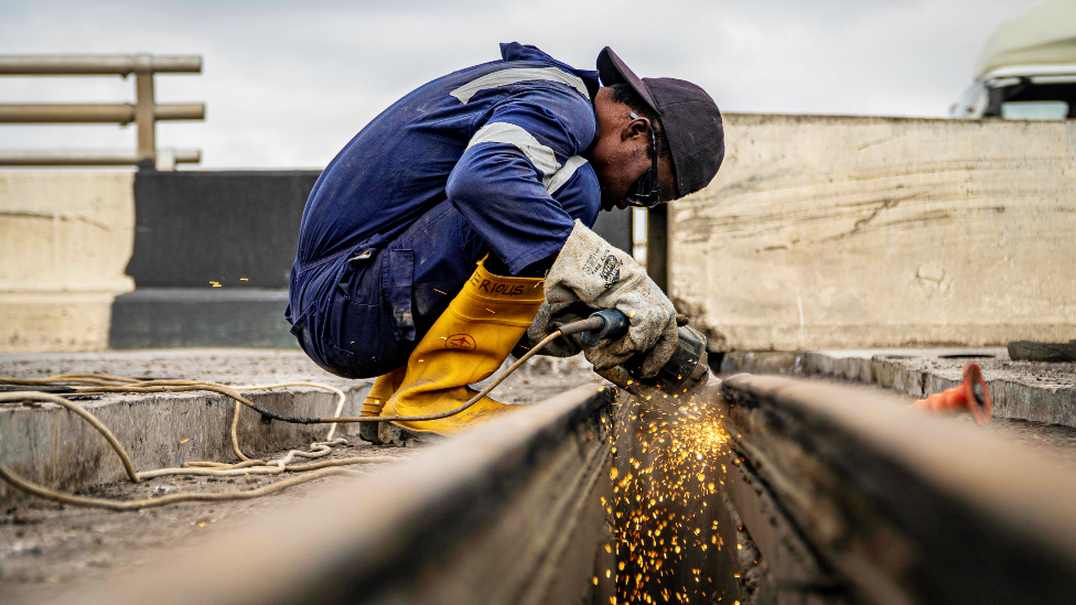 A welder on the Third Mainland Bridge, Lagos, Nigeria