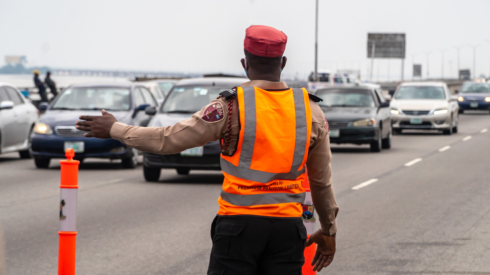 Someone directing traffic on the Third Mainland Bridge, Lagos, Nigeria