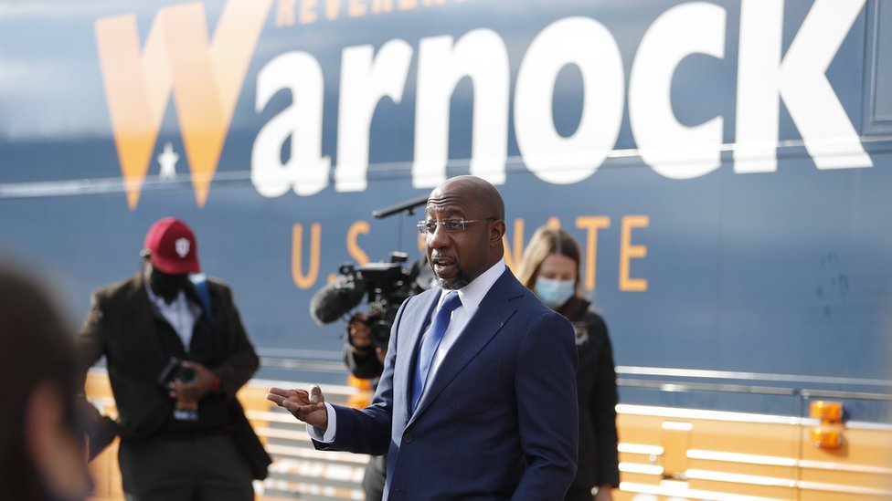 Raphael Warnock speaks outside his campaign bus at a canvassing kick off event in Marietta, Georgia, USA, 5 January 2021