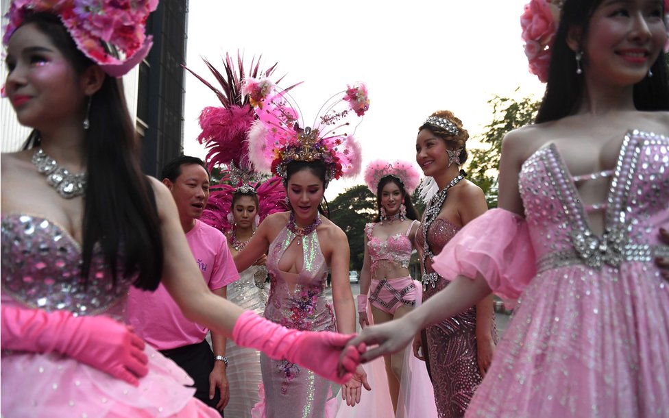 Transgender performers are seen in colourful costumes