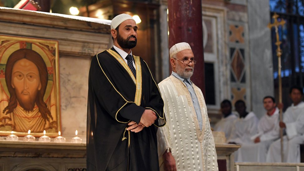 Imam Sami Salem (L) and Imam Mohammed ben Mohammed (R) stand during a mass in Santa Maria church in Rome