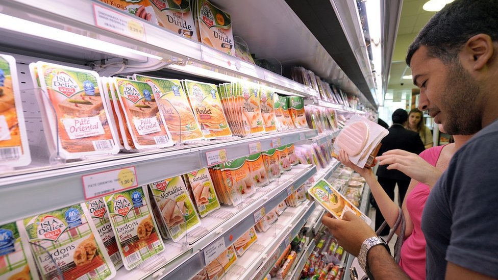 Consumers browse halal meat products in France