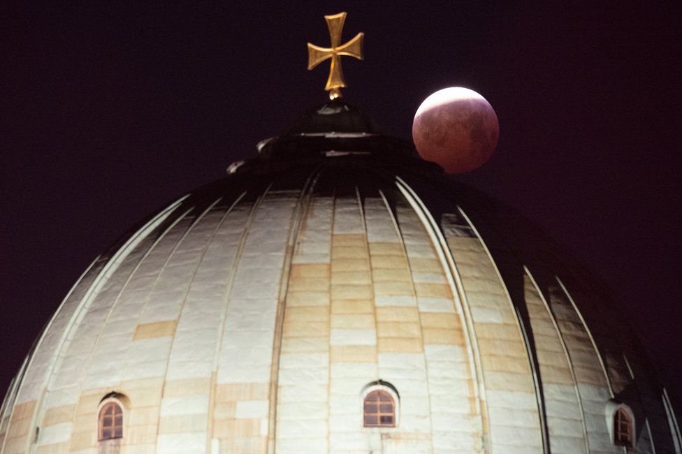 A view of the lunar eclipse above the St Elizabeth Church in Nuremberg, Germany