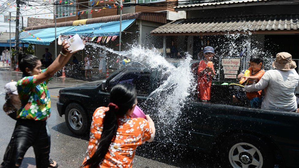Revellers throw water on passing motorists