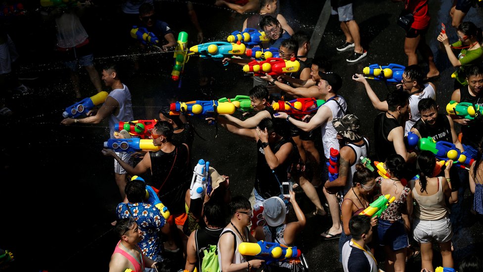 People play with water pistols to celebrate the water festival