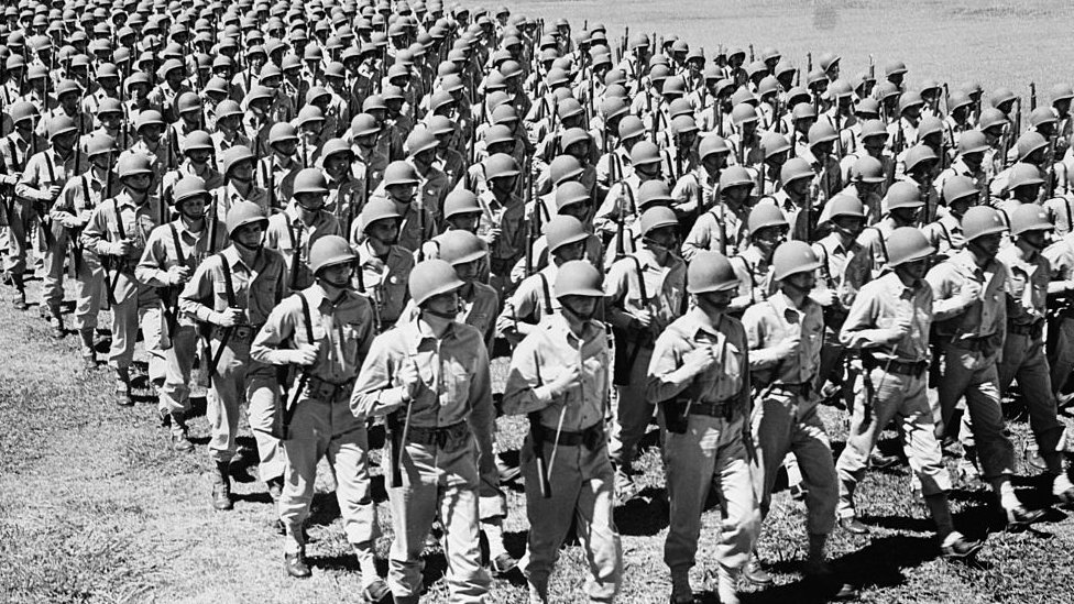 Soldiers marching during the 1940s