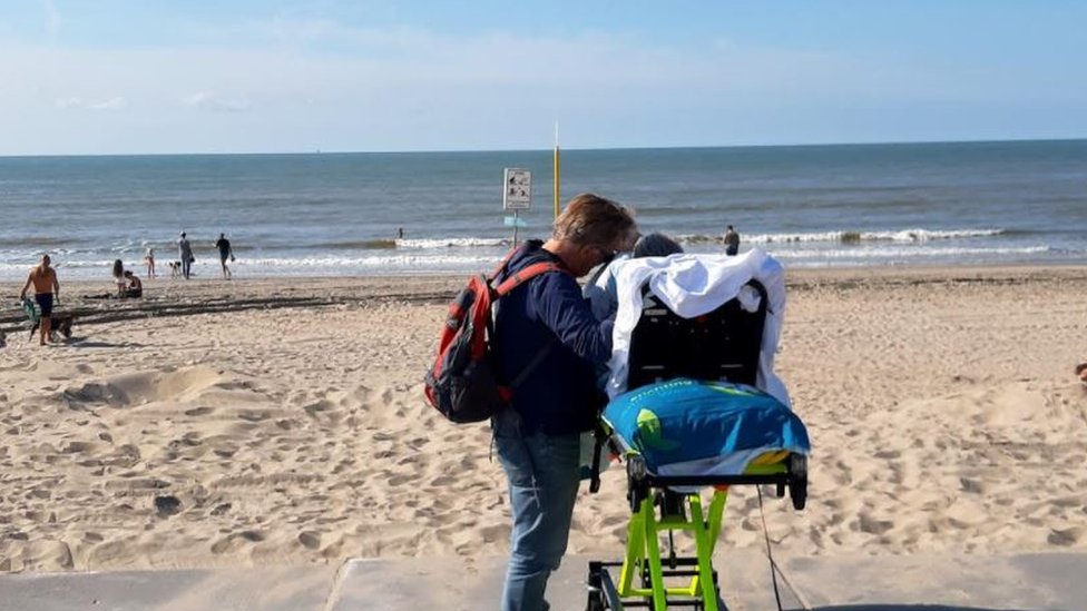 An elderly couple watching the waves