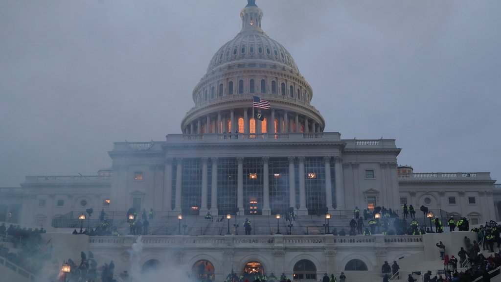 Supporters of Donald Trump clash with police officers in front of the US Capitol