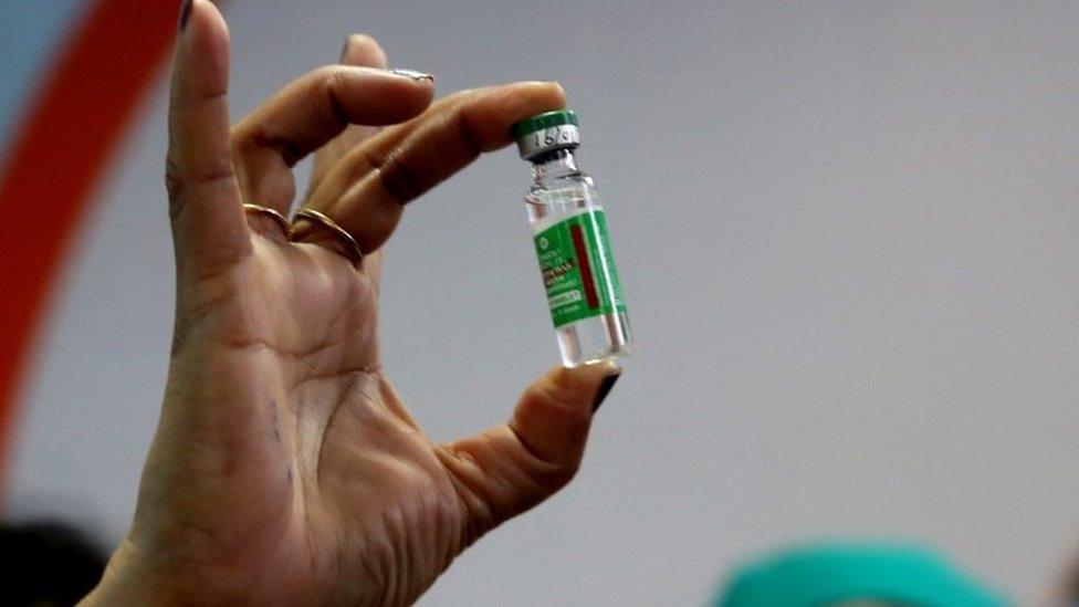 An Indian Health official displays a COVID-19 vaccine manufactured by the Serum Institute of India, at the All India Institute Of Medical Sciences (AIIMS) in Bhopal , India,16 January 2021