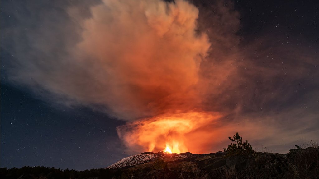 Mount Etna erupting at night