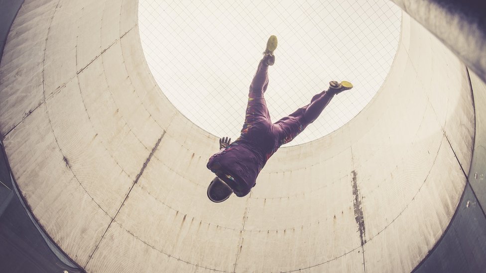 Stock image of person indoor skydiving