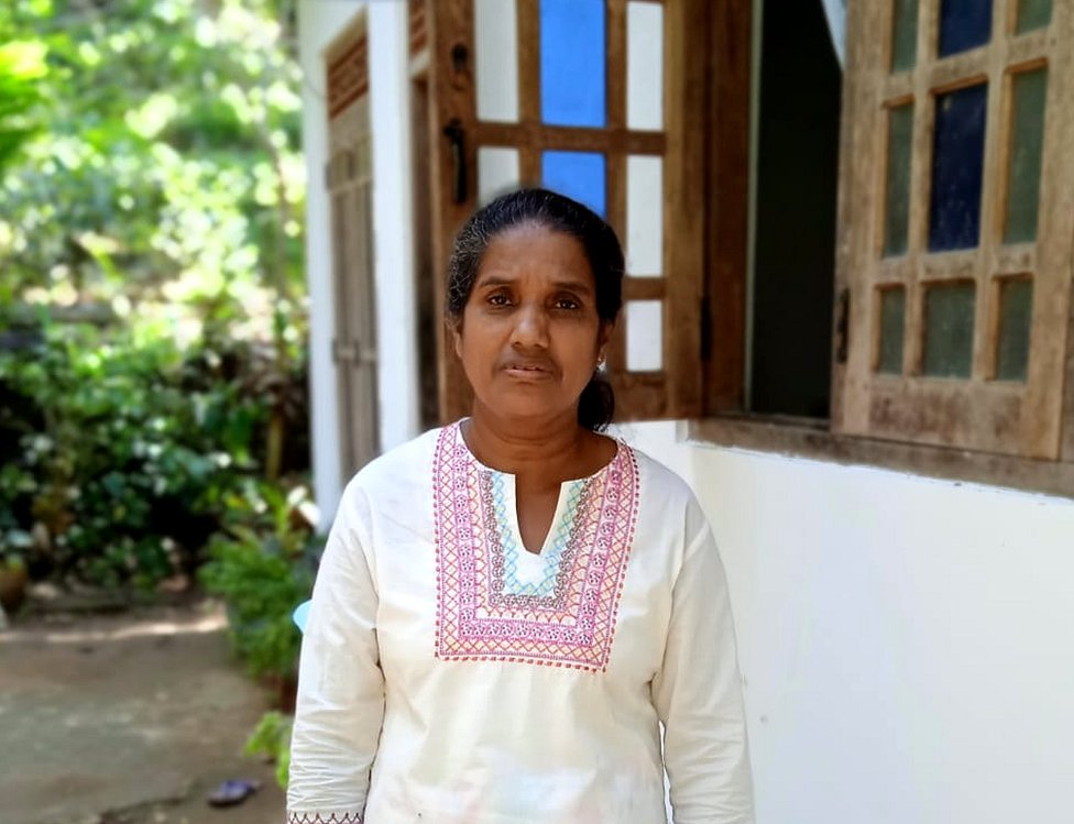 Yasawathie in front of her house