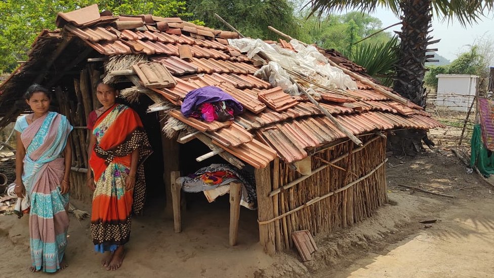 Women of Kanal Tola outside their period hut
