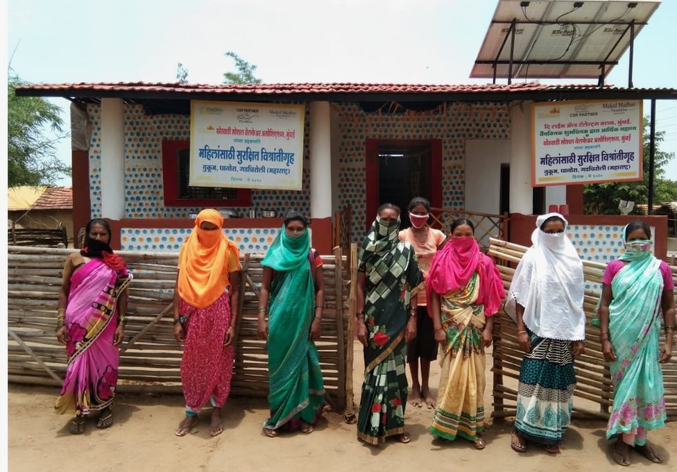 Women of Tukum outside their period hut