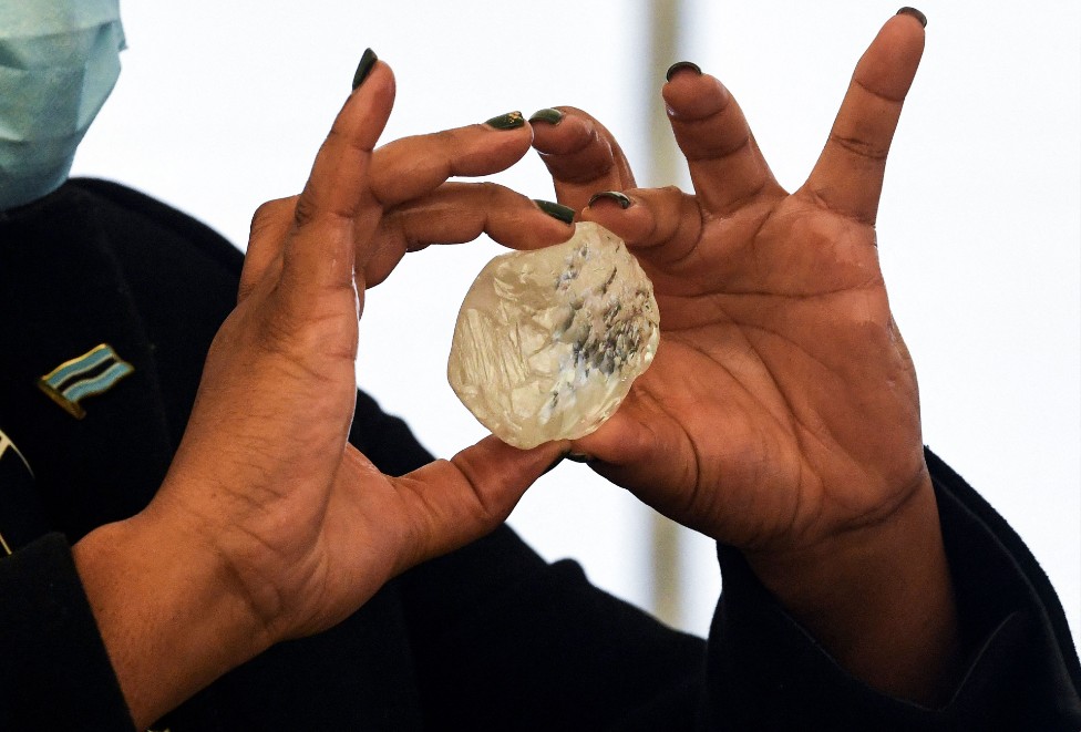 A woman's hands holding a diamond