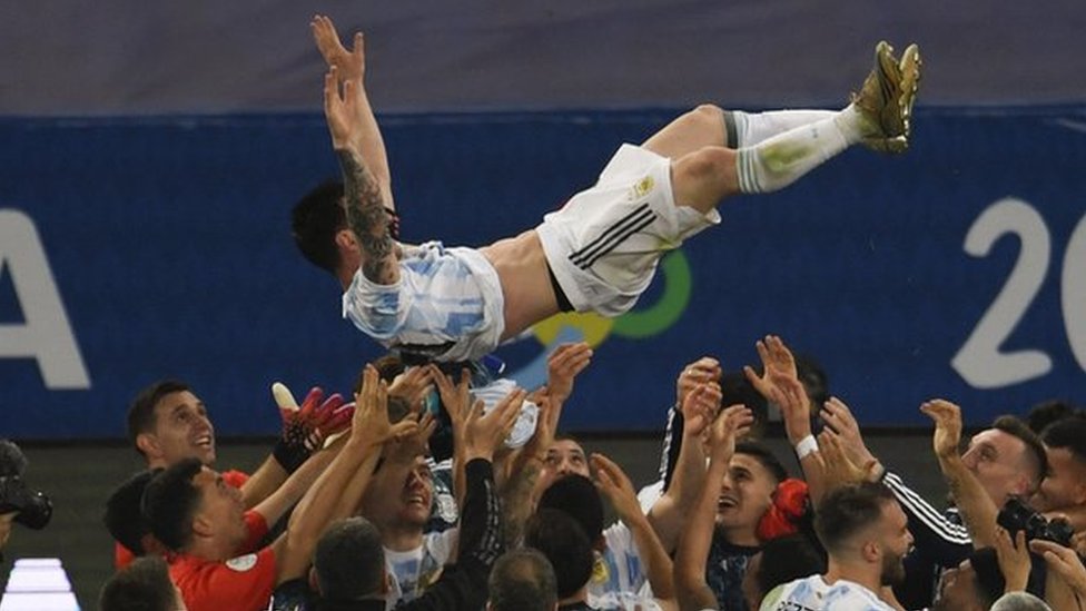 Messi is thrown in the air by his team-mates at full-time