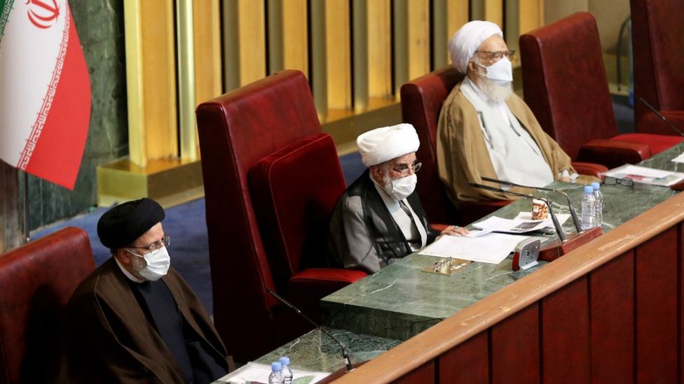 Chairman of the Assembly of Experts Ahmad Jannati (C) and Judiciary Chief Ebrahim Raisi (L) attend an Assembly of Experts meeting in Tehran, Iran on 22 February 2021