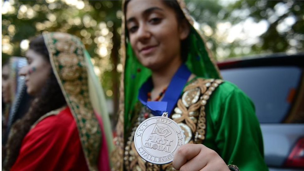 One of the Afghan team members at the 2017 International Robotics Championship shows her medal