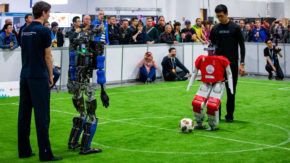 Robots being prepared for a RoboCup Humanoid League game