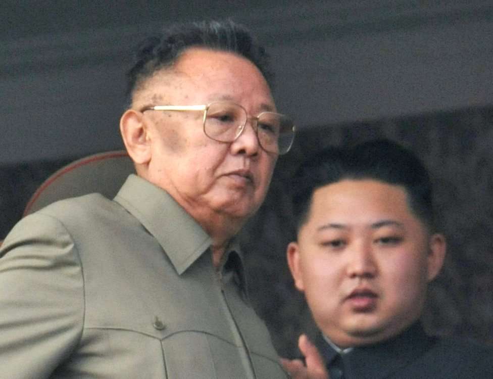 North Korean leader Kim Jong-il (L) walks in front of his youngest son Kim Jong-un as they watch a parade to commemorate the 65th anniversary of the founding of the Workers