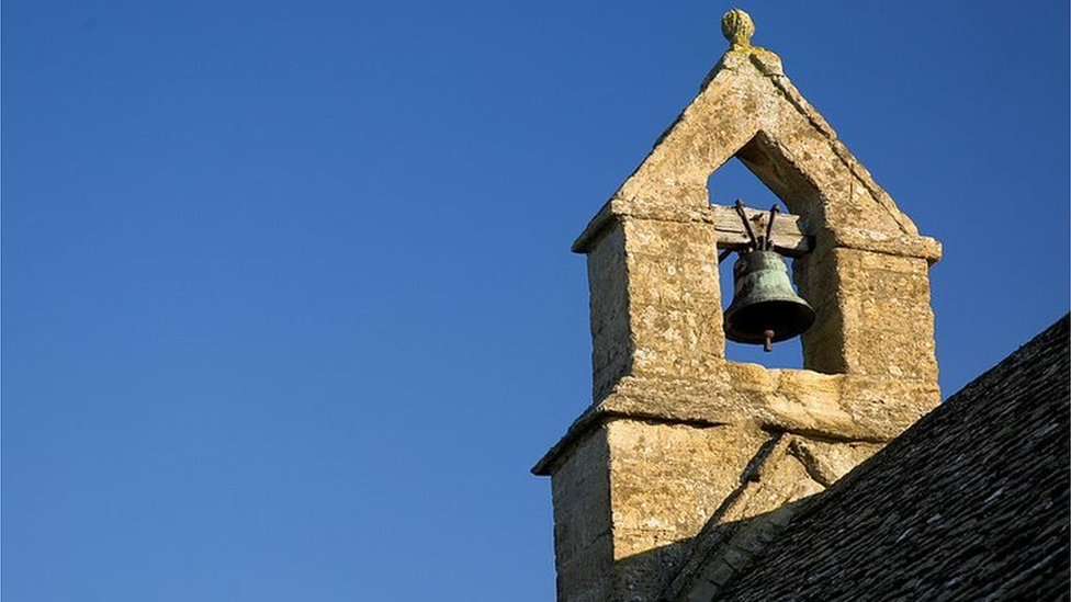 A church bell tower against a blue sky