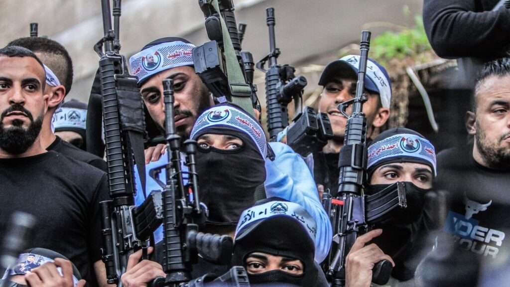 Masked Palestinian gunmen from the Al-Aqsa Martyrs’ Brigades of the Fatah movement, in Balata refugee camp, in the occupied West Bank, carrying their weapons during a demonstration in 2017 for Palestinians shot dead by the Israeli army
