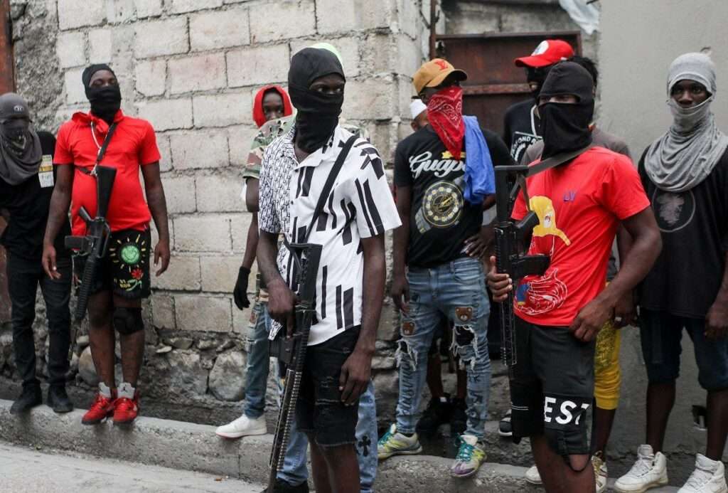 Armed gang members with scarves over their faces