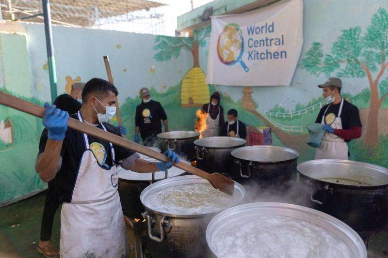 A group of aid workers cooking food in large pots