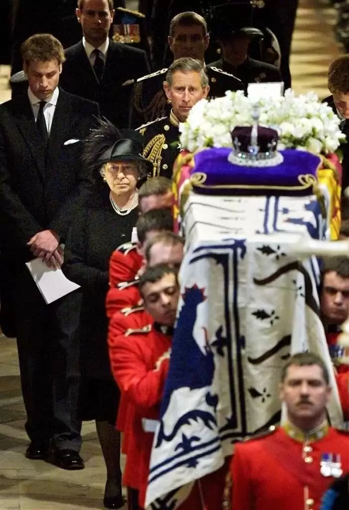 Queen Elizabeth II (front, C) leads her family as she follows pall bearers carrying the coffin of Queen Elizabeth, the Queen Mother out of Westminster Abbey after the funeral service in London 09 April 2002.